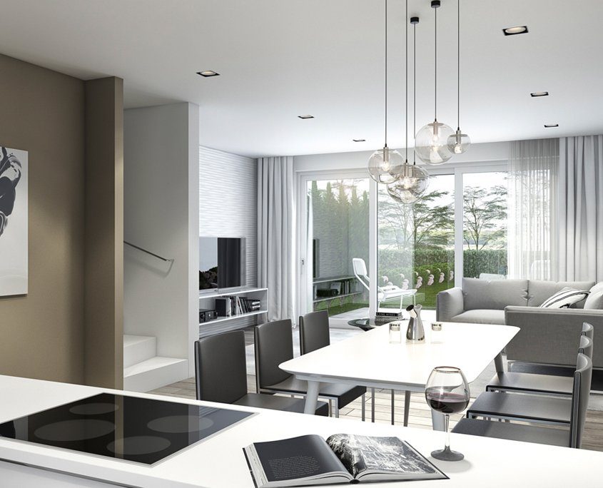 Heller Wohn-Essbereich mit weißem Tisch, dunkel grauen Stühlen darum und hell grauem Sofa.