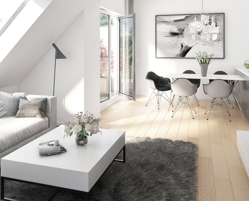 Heller Wohn-Essbereich mit dunkelgrauem Teppich auf hellem Holzboden. Darauf ein weißer Couchtisch und ein hellgraues Sofa. Im Hintergrund ein weißer Esstisch mit 5 weiß/grauen Stühlen darum