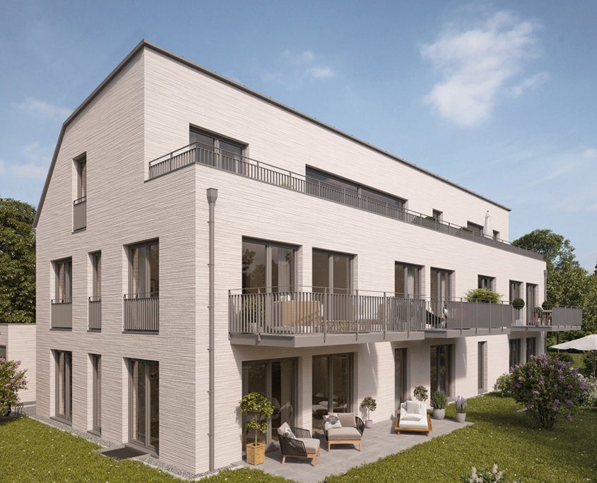 Helles Reihenhaus mit grauen Balkonen und grünem Garten