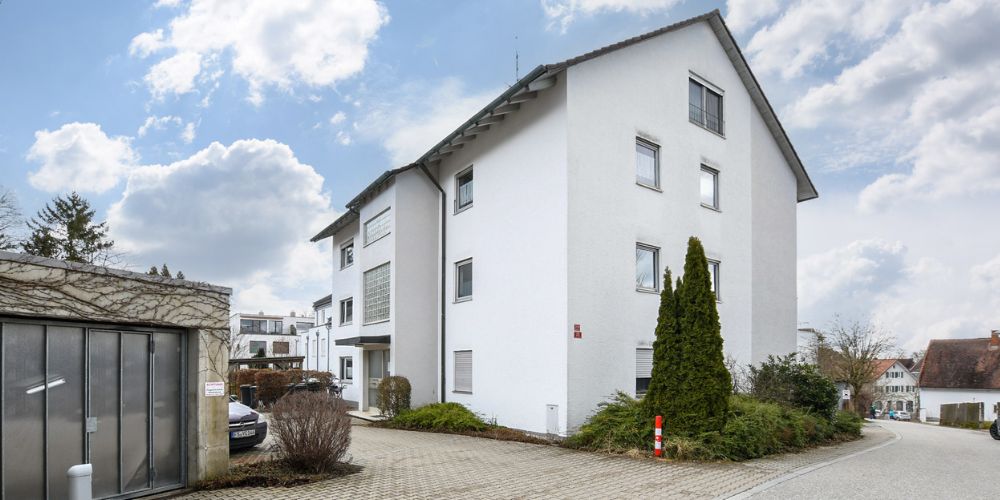 Modernes Mehrfamilienhaus in München mit gepflegter Außenanlage, Stellplätzen und ruhiger Wohnstraße in gewachsener Wohngegend