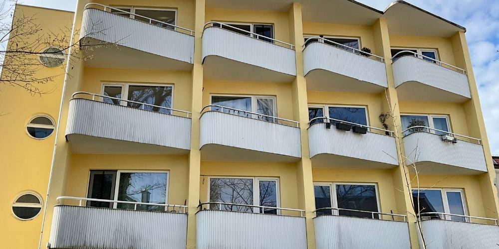 Gepflegtes Mehrfamilienhaus mit großzügigen Balkonen und heller Außenfassade in ruhiger Wohnlage